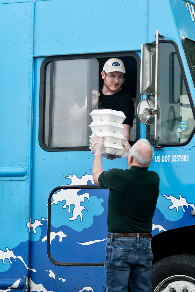 Jessy Braddy hands Russ DeVenney his order